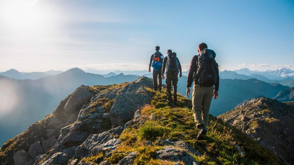 Austria, Max and friends hiking on ridge in Alps