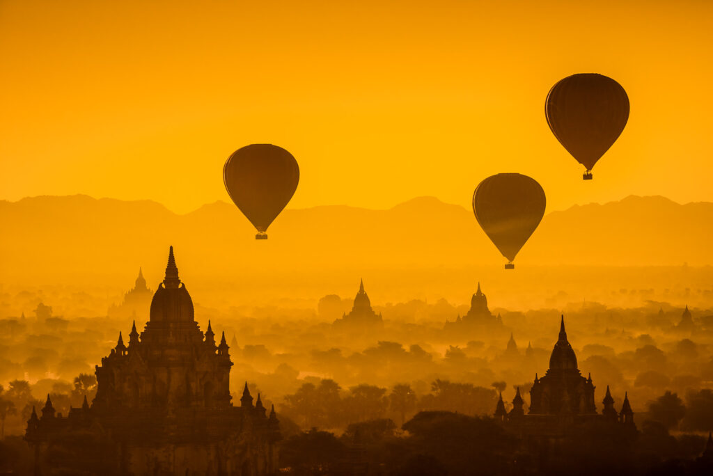 Hot air balloon over plain of Bagan in misty morning, Myanmar