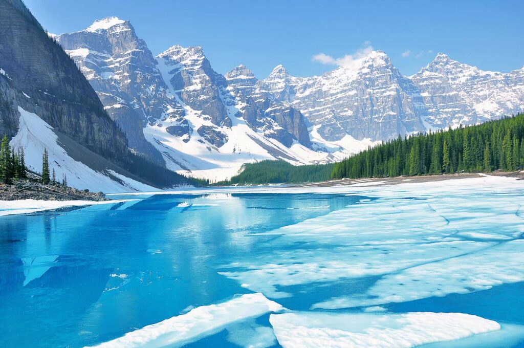 Moraine lake under the ice at morning spring time. Banff National park. Canada.