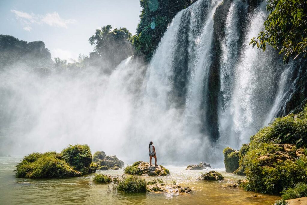 catherine standing underneath the smaller vietnamese side only ban gioc waterfall