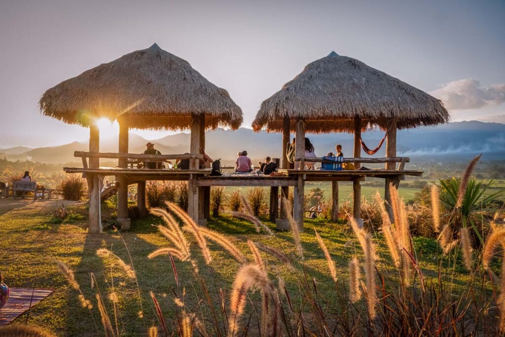 two huts, one of the best sunset attractions in pai thailand. a stop on a motorcycle tour to Chiang rai from chiang mai