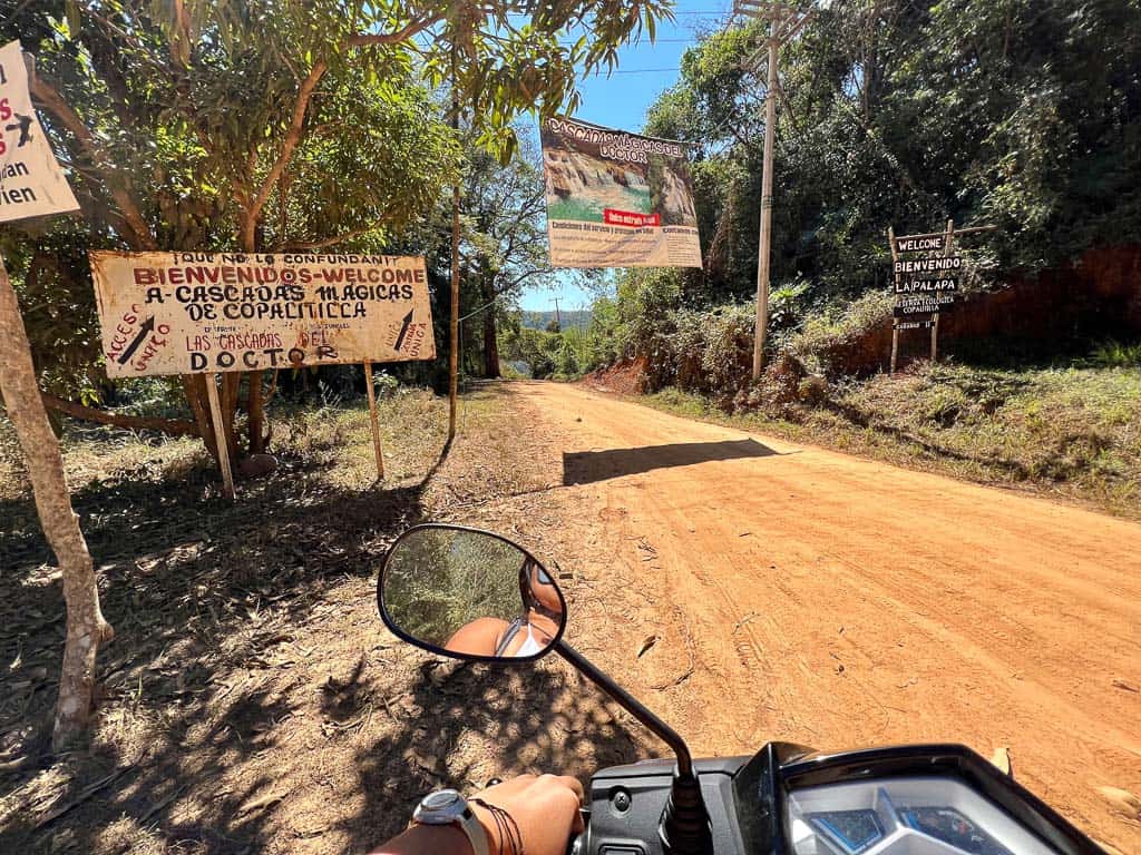 Signs  and scooter going to the Copalitilla huatulco waterfalls