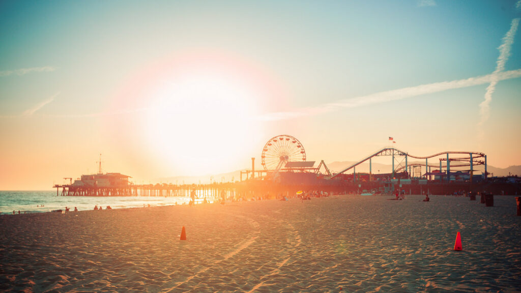 santa monica pier silhouette of the amusement park during sunset, one of the best beaches in los angeles vs san francisco rocky shores