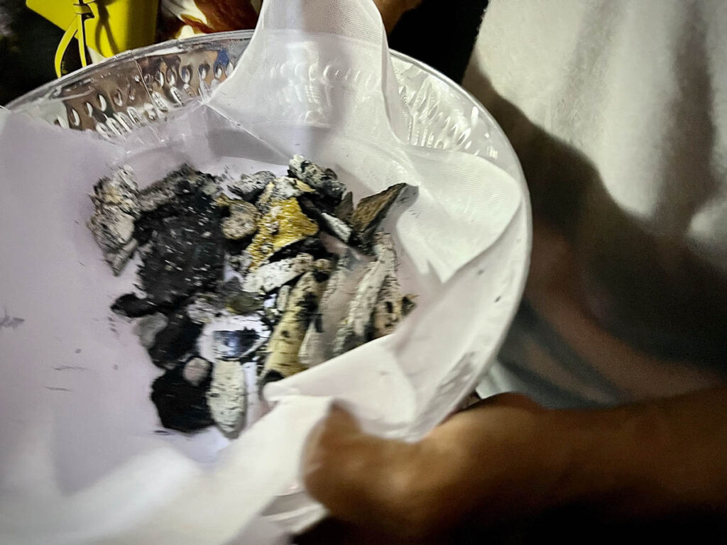 bone shards of the final cremation pyre of bones in a silver bowl