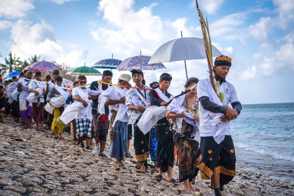 ngaben parade of mourners holding skeletons