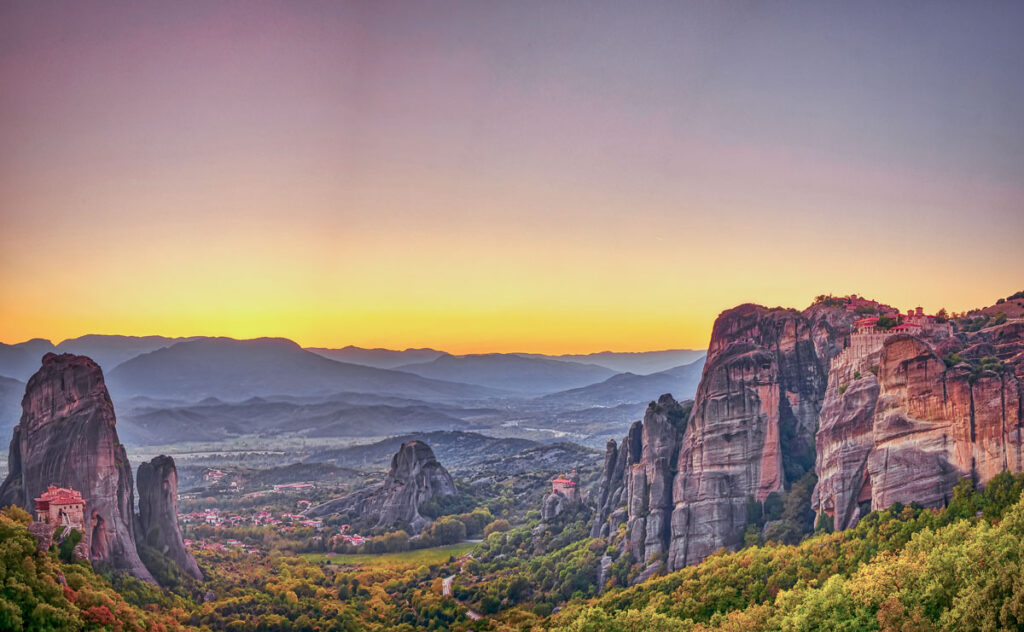 Landscape with monasteries and rock formations in Meteora, Greece. during sunset.