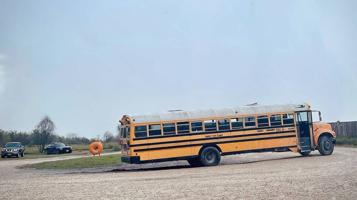 Bus struggling to push out of the mud