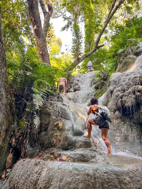 Cat Xu climbing up the bua tong sticky waterfalls near chiang mai