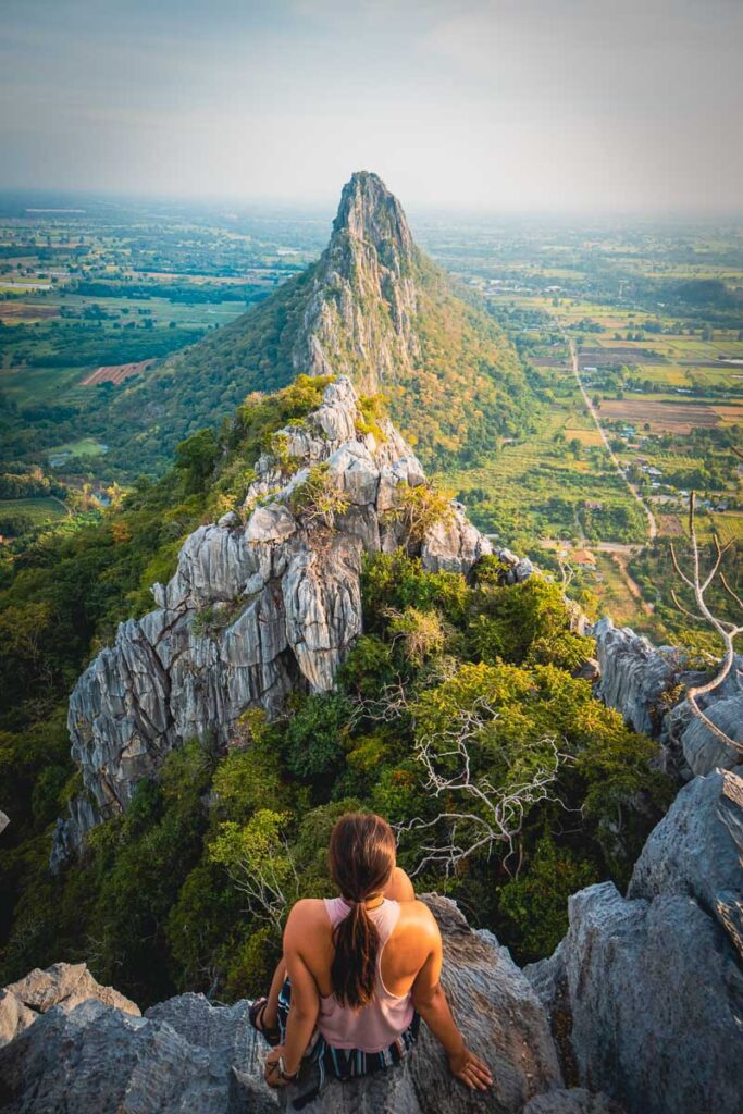 Nomadicated sitting on khao noi, one of the most incredible places to visit around sukhothai thailand