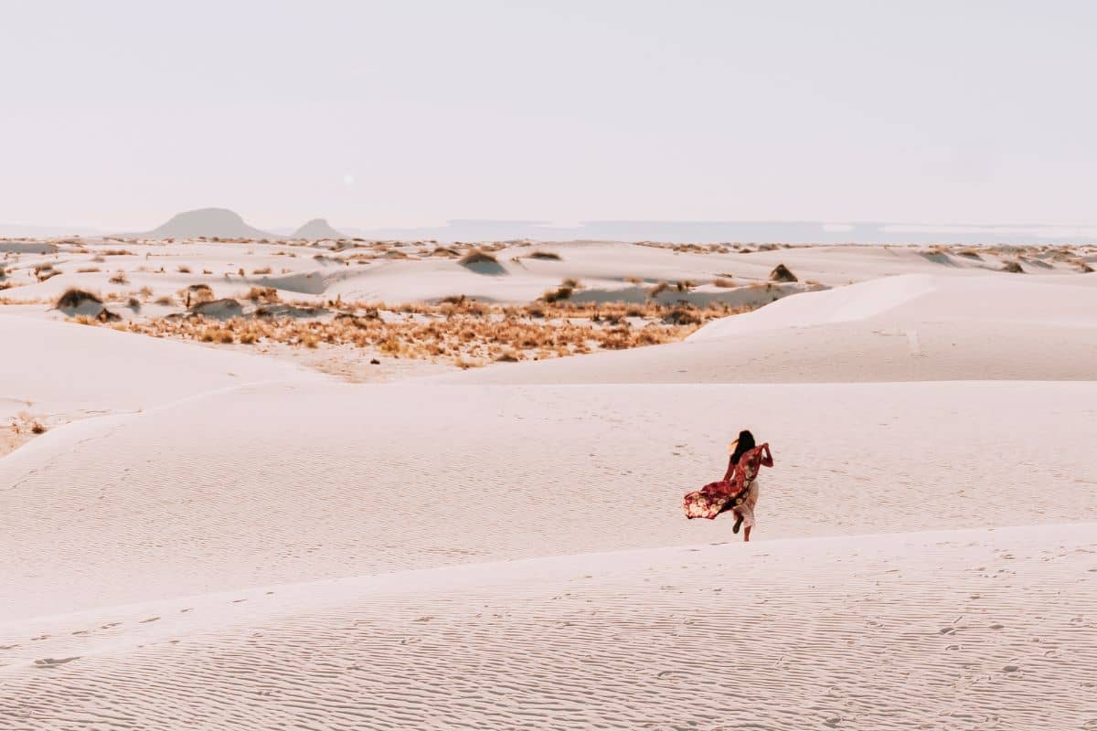 Nomadicated in a remote desert fulfilling her bucket list in White Sands National Park in New Mexico