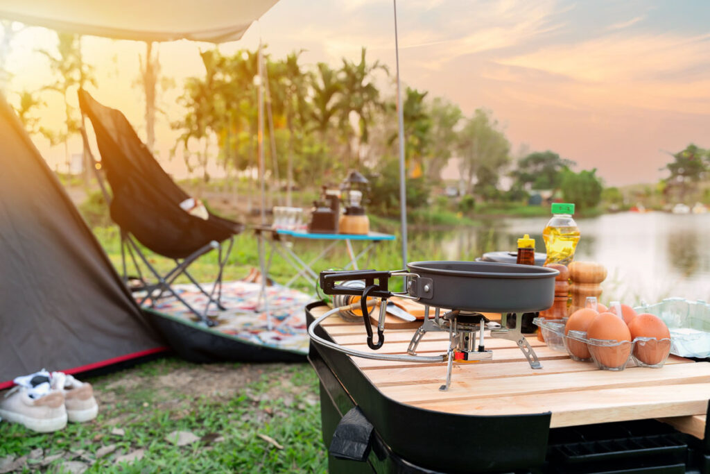 Cooking food during camping at natural park in Thailand. Recreation and journey outdoor activity lifestyle.