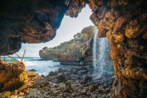 jogan beach, a yogyakarta beach where a freshwater waterfall flows into the sea